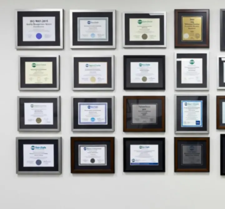 Framed certifications and accreditations displayed on a wall for PIPSI LTD